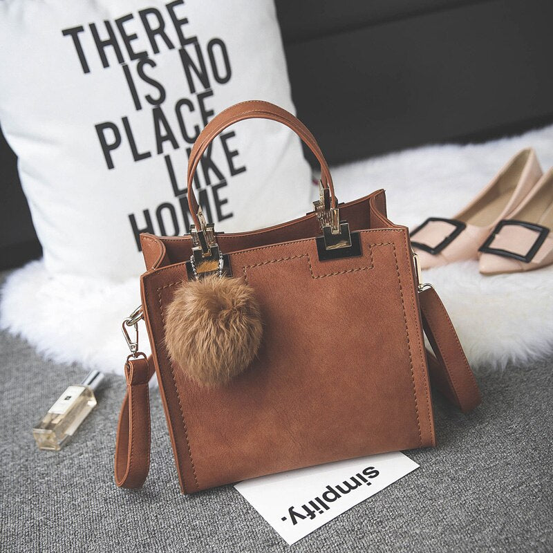 Suede Leather handbag with fur ball