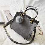 Suede Leather handbag with fur ball